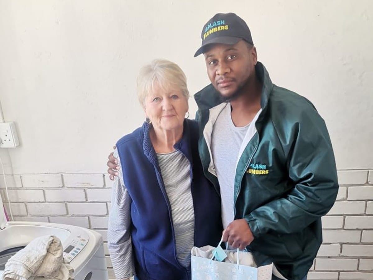 Splash Plumbers team member with a client after a completed job