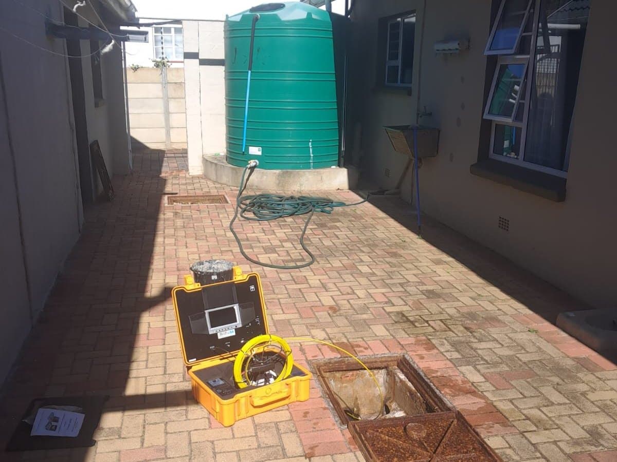 Drain line inspection at a manhole in a backyard