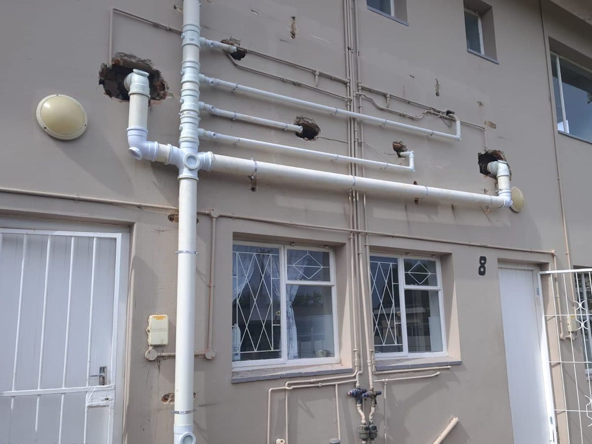 New pipework and a downpipe on the outside of a house