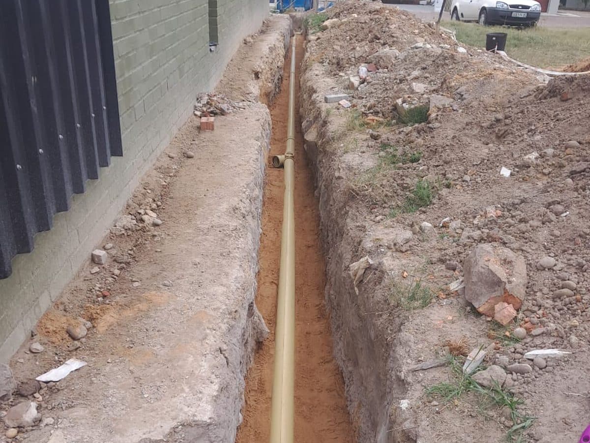 Drain trench alongside a house wall