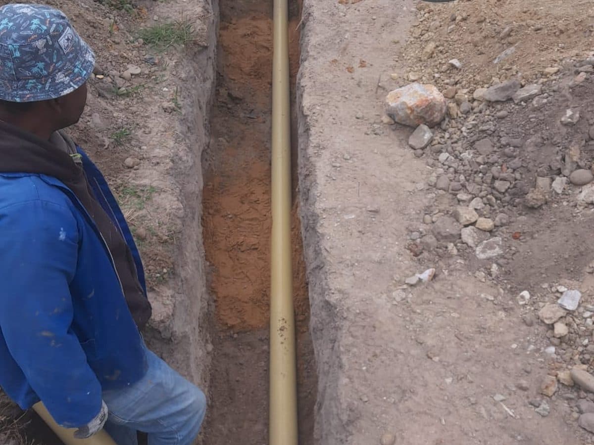 Splash Plumbers technician working in a drain trench