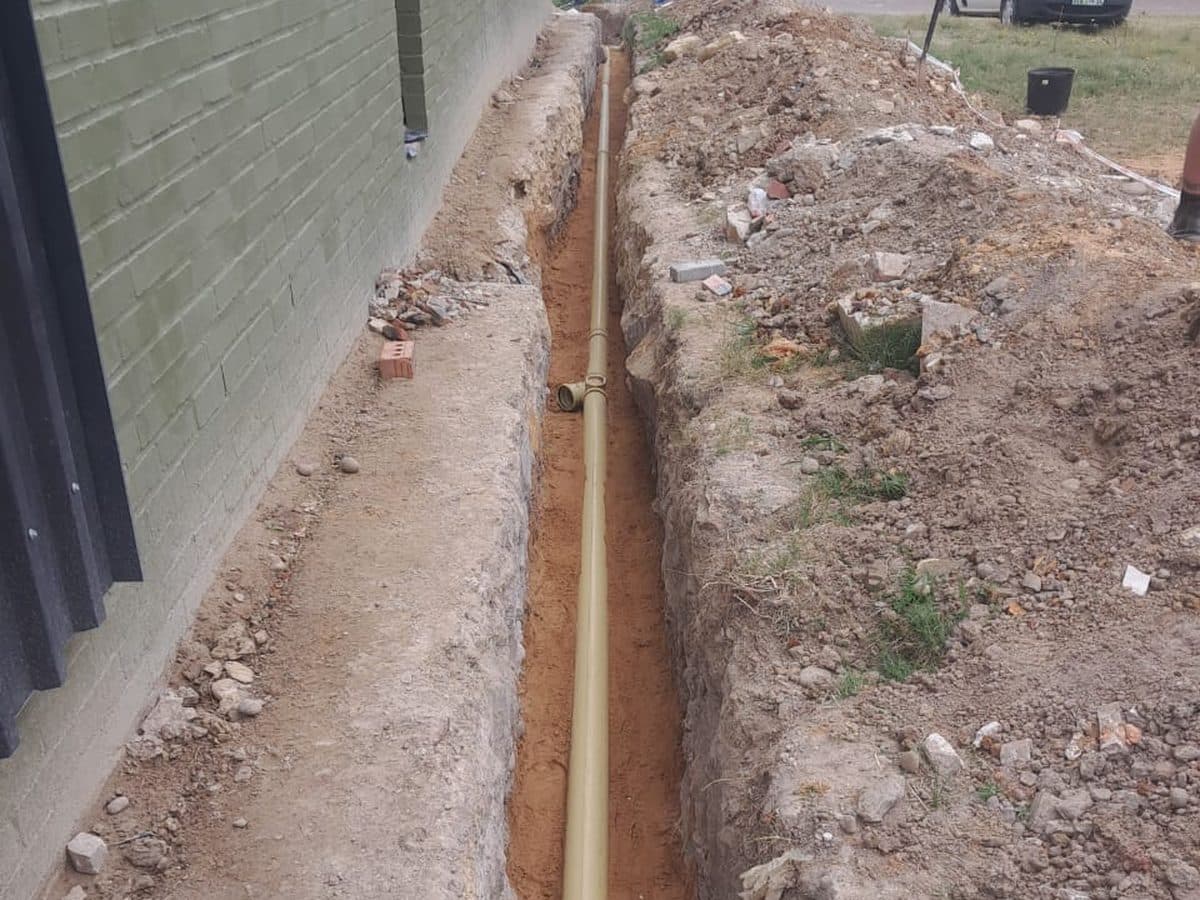 Drain trench dug beside a boundary wall