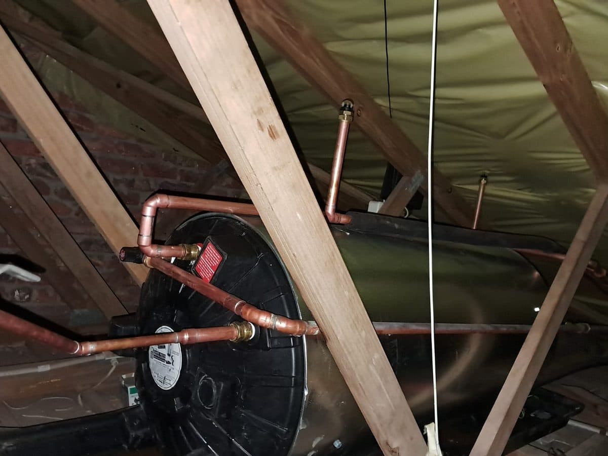 Geyser cylinder and copper pipework in a roof space