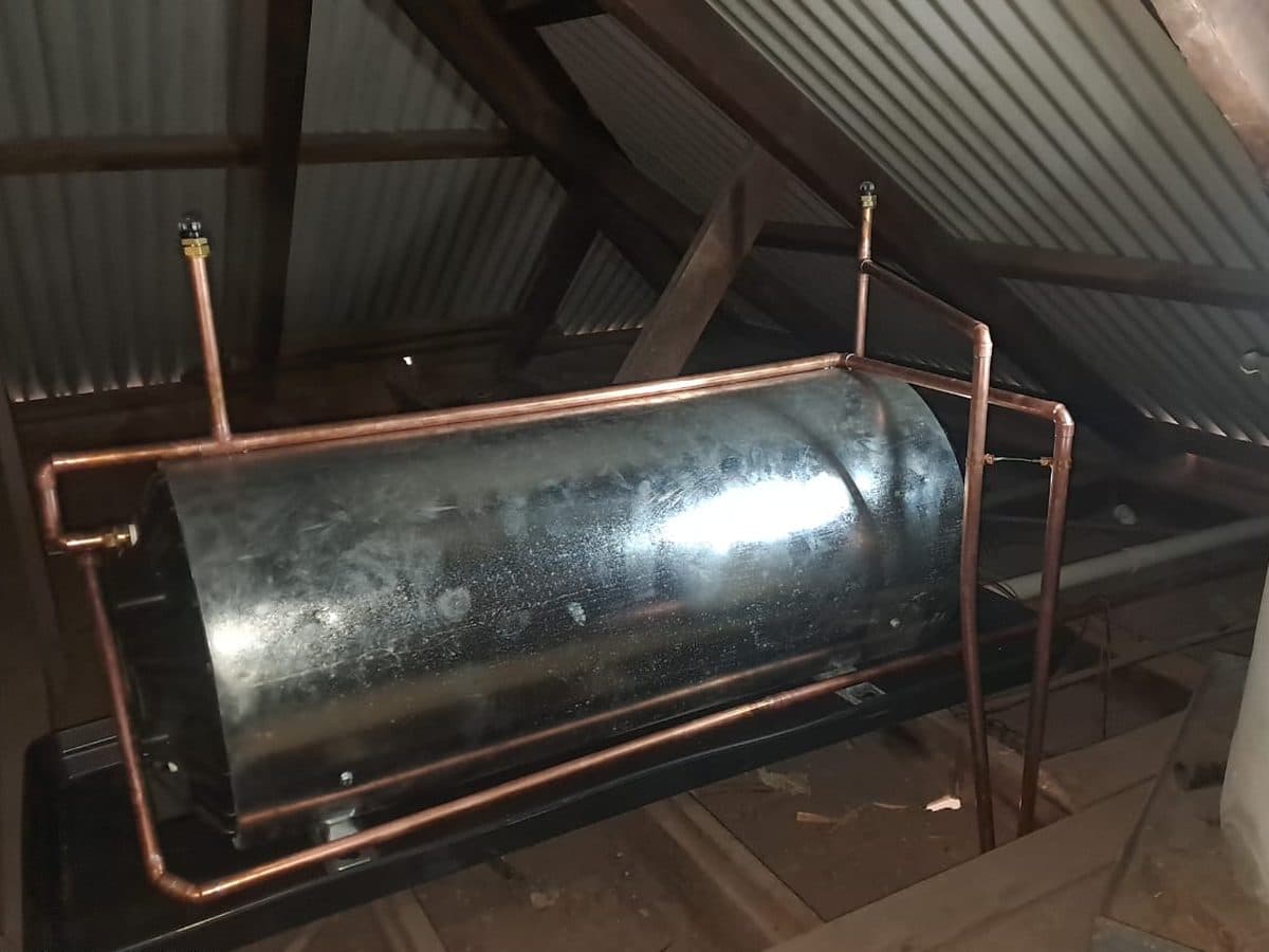 Geyser cylinders on a stand in a roof space