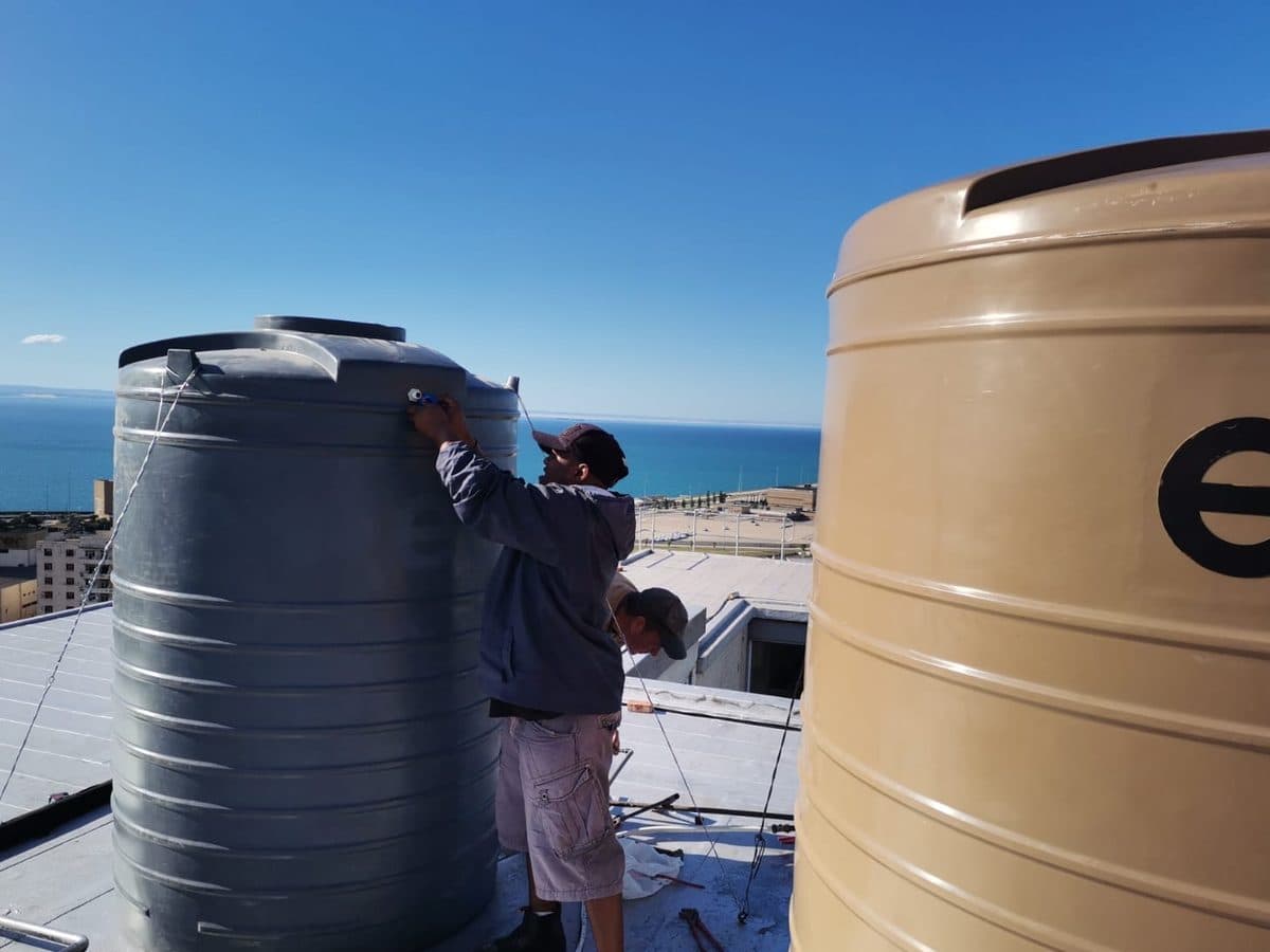 Water tanks installed on a rooftop during a maintenance job in Gqeberha