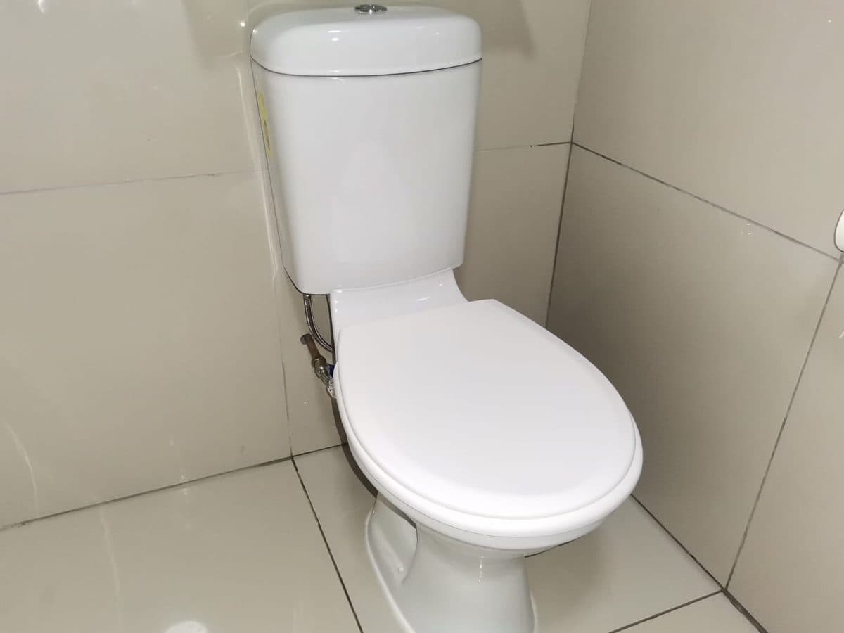 Toilet installed in a tiled bathroom