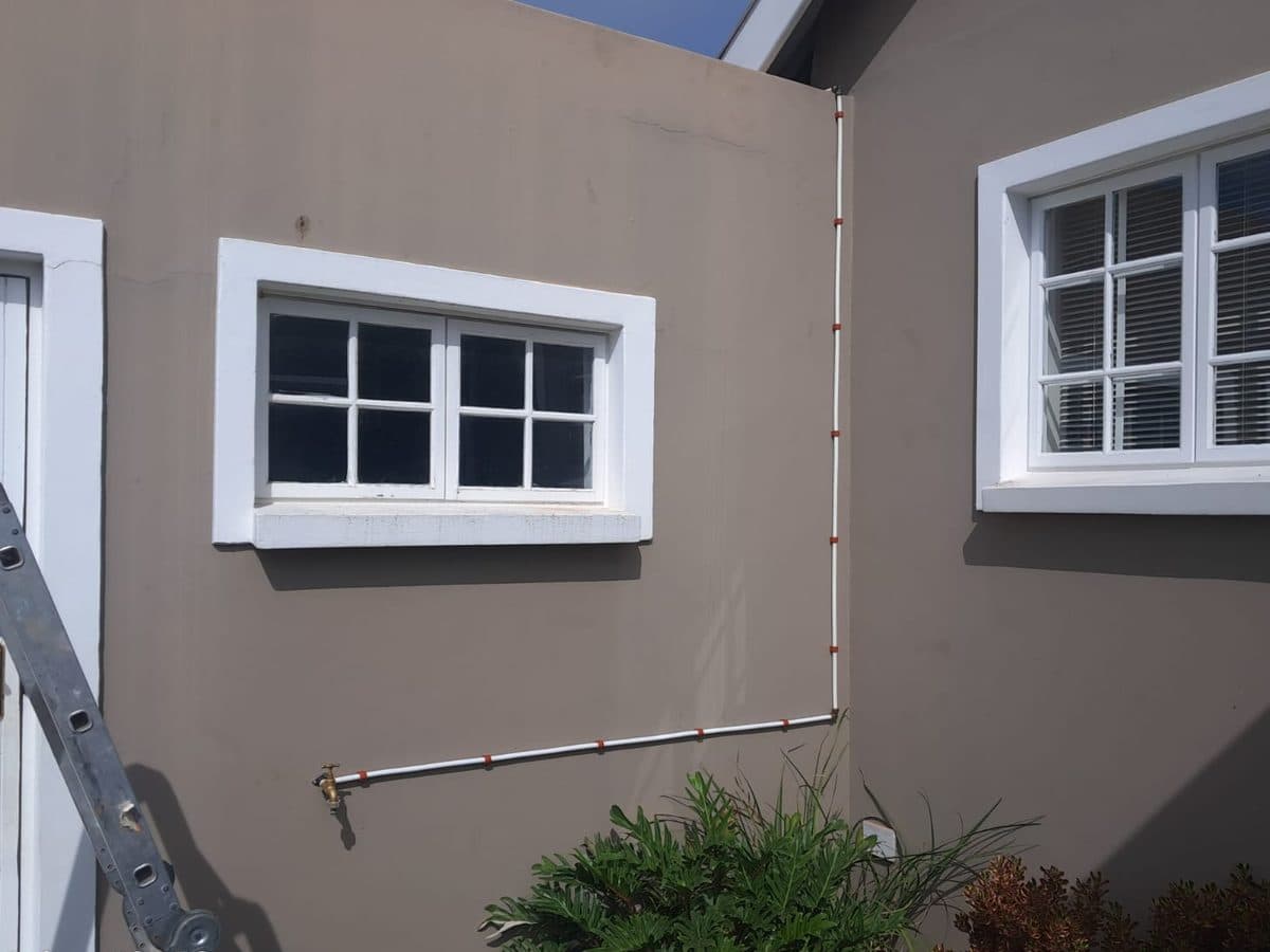 Downpipe fitted beside a window