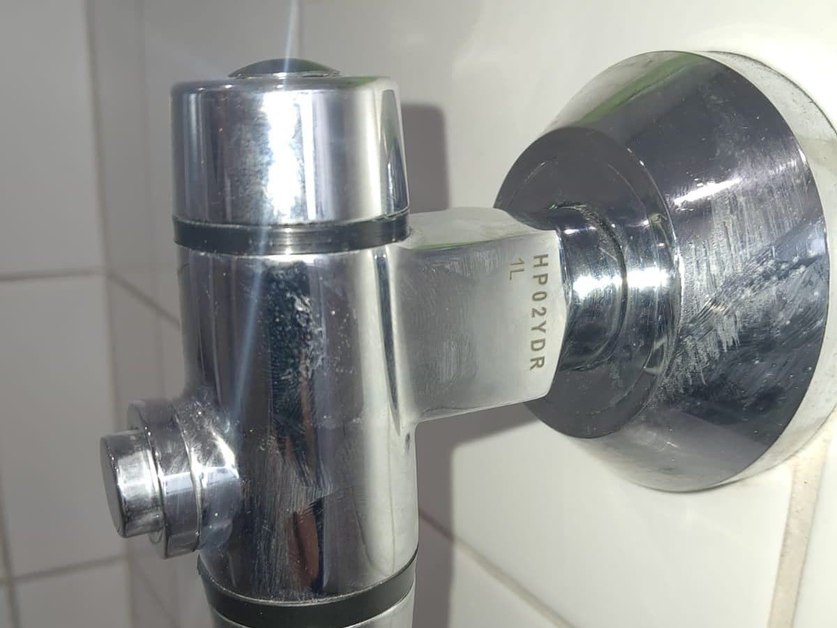 Shower mixer and head fitted on a tiled wall