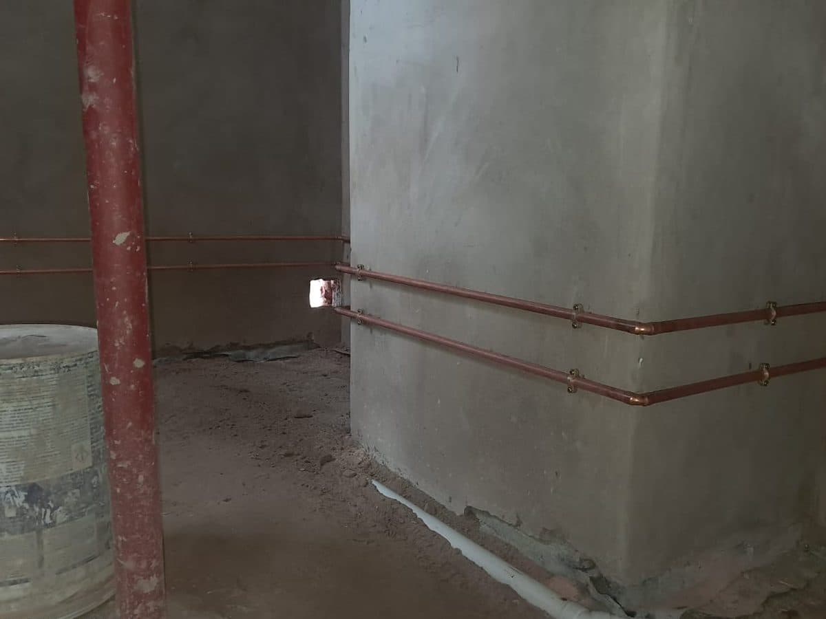 Copper pipework installed around a pillar