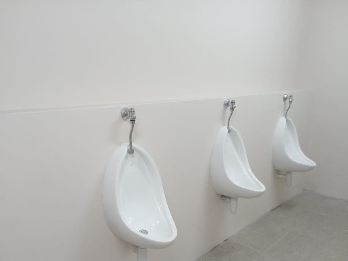 Wall-mounted urinals fitted in a new bathroom