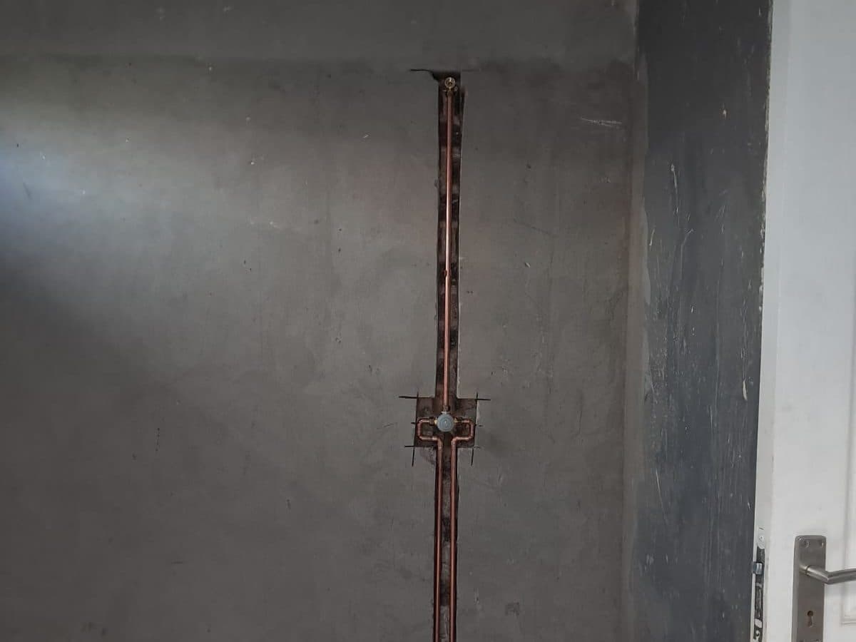 Copper pipework run up a wall in a new room