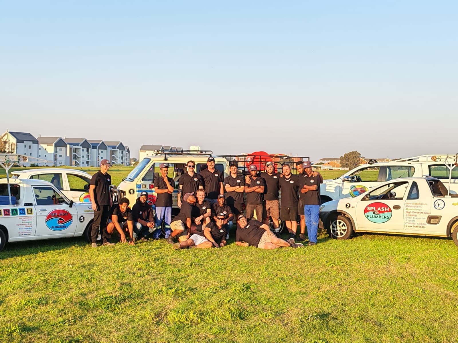 The full Splash Plumbers crew in front of their branded vans in Gqeberha