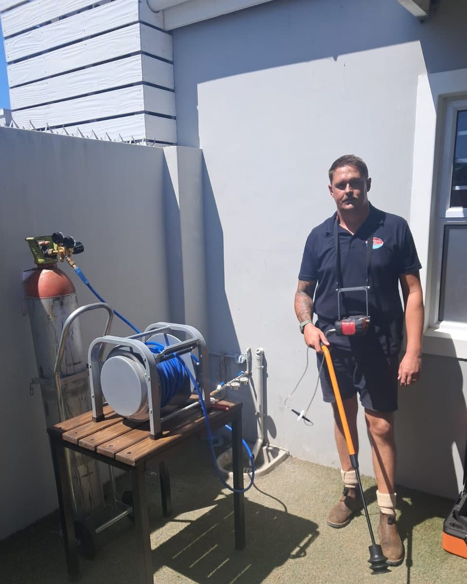 Splash Plumbers technician with the acoustic listening stick and tracer gas equipment on site